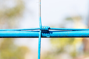 Steel wire fence from the grid with blue polymer coating. Knotted Fence. Tensile Mesh knotted wire...