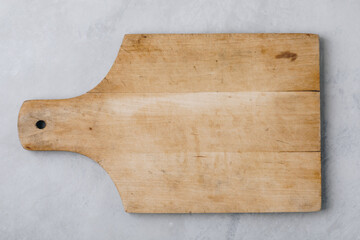 Empty vintage cutting board. Wooden cutting board on gray stone background. Top view