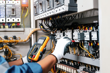 Electricity or electrical maintenance service, Electrician hand holding measuring meter checking...
