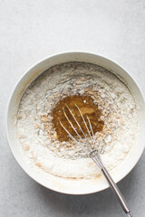 Flour being mixed into cake batter, flour being added to blondies batter, process of making blondies