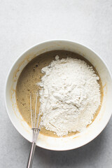 Flour being mixed into cake batter, flour being added to blondies batter, process of making blondies