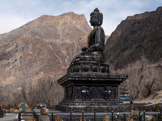 Muktinath temple, Annapurna Circuit trek. 35 feet carved stone Buddha located in the temple complex.