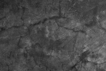 Dark black and gray blurred wall background has a little abstract light