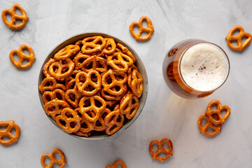 Mini Pretzels with Salt in a Bowl on a gray background, top view. Flat lay, overhead, from above.