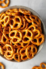 Mini Pretzels with Salt in a Bowl on a gray background, top view. Flat lay, overhead, from above.