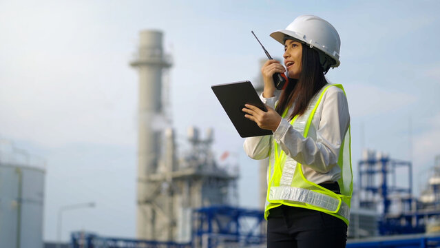 Industrial Engineer Using Digital Tablet For Work Against The Electrical Plant