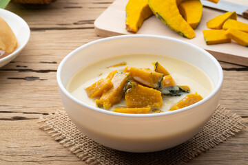 Coconut Milk Stewed Pumpkin,Thai dessert boiled sliced Pumpkin fruit in coconut milk with palm sugar in white bowl