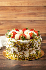 Strawberry cake. Cream and fruit cake on a wooden floor. close up