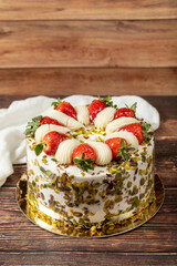 Strawberry cake. Cream and fruit cake on a wooden floor. close up