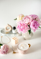 Fototapeta na wymiar Cup with cappuccino, flowers peony, morning concept, woman's day