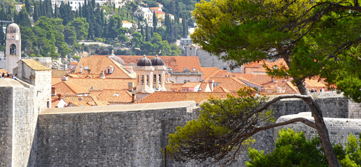 view of many landmarks of the old town in the city of Dubrovnik, Croatia with classic red tiled rooftops
