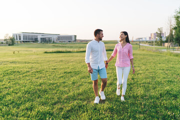 Happy couple walking in field