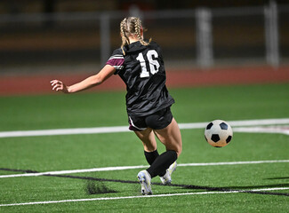 Young kids playing a competitive game of soccer and making great plays