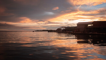 sunset in the bay of the island with orange clouds