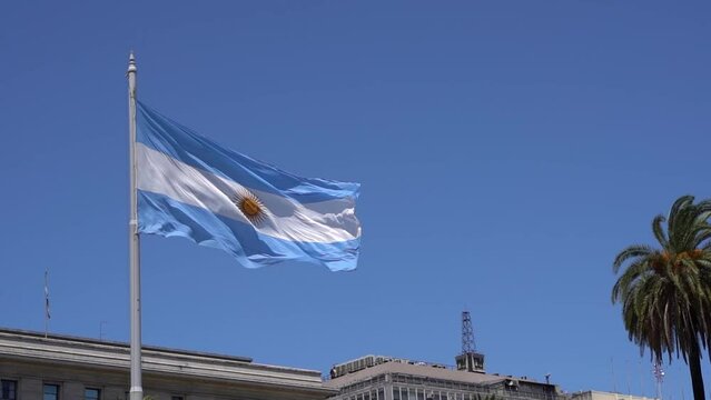 Argentinean flag against the blue sky in Buenos Ares. The national blue and white flag of Argentina.