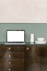 Laptop computer on vintage console table, tropical plant monstera. Aesthetic elegant blog, online shop, store, social media