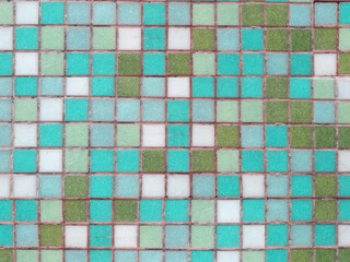 Colorful old mosaic square tiles. Square bricks, background texture. Old tile wallpaper. natural surface weathering