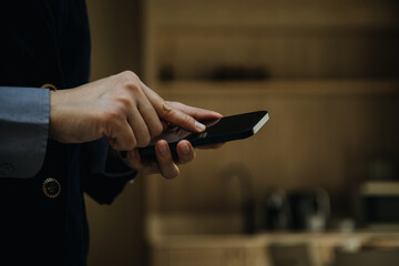 Mature businessman using a digital tablet to discuss information with a younger colleague in a modern business lounge
