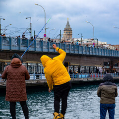 people fishing in eminonu with galata and galata bridge