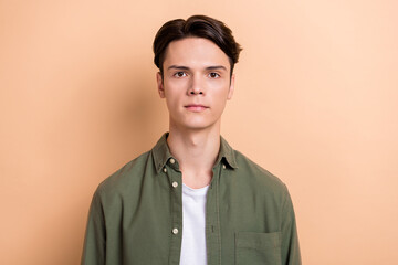 Photo of calm focused concentrated young man nice new haircut isolated on beige color background