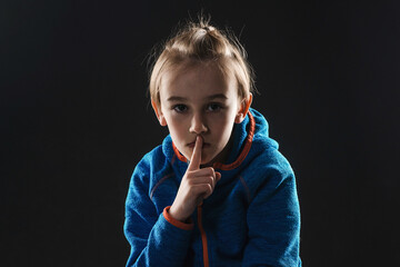 Young boy suffering from anxiety. Stressed alone boy over black background. Unhappy young boy with...