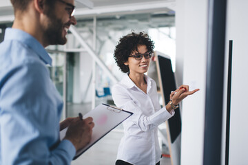 Fototapeta premium Business man and woman work at interactive board