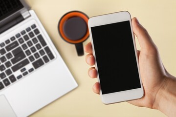 Blank screen phone on laptop background