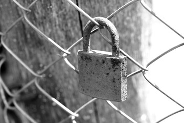 old rusty padlock on an iron fence close-up