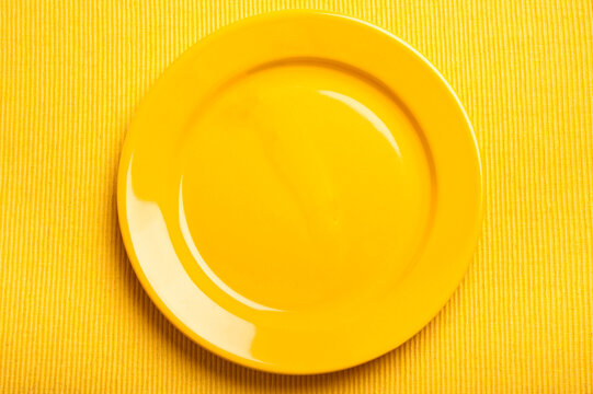 yellow plate over yellow background like a graphic background 
