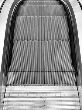 Overhead view of metal escalator stairs