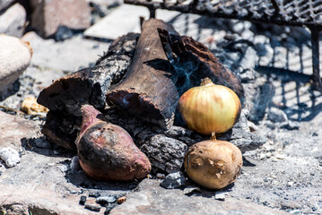 vegetables, potato, onion and sweet potato cooking in the fire, cooking in the brazas, typical Argentinian