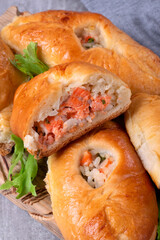 Rasstegai buns with red fish, rice and roasted onion. Russian yeast dough bakery product - obrazy, fototapety, plakaty