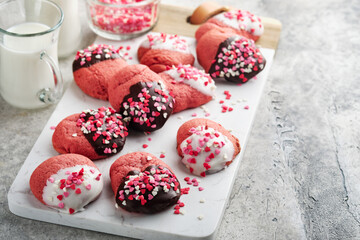 Valentines day cookies. Shortbread cookies with glaze white and dark chocolate and heart sprinkles on plate on white background. Mothers day. Womans day. Sweet holidays baking. Top view.