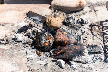 vegetables, potato, onion and sweet potato cooking in the fire, cooking in the brazas, typical Argentinian