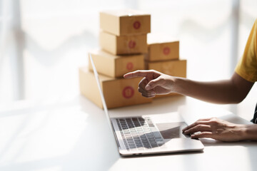 Close up view of young small businesses SME owners female entrepreneurs check online orders to prepare to pack the boxes, sell to customers, sme business ideas online...