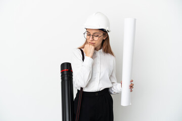Young architect woman with helmet and holding blueprints isolated on white background having doubts