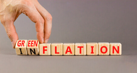 Inflation or greenflation symbol. Concept words Inflation or Greenflation on wooden cubes. Beautiful grey background. Businessman hand. Ecological business inflation greenflation concept. Copy space.