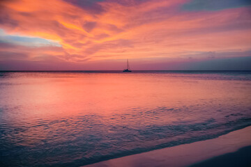 Palm Beach on Aruba island in the Caribbean Sea at dramatic sunset, Dutch Antilles