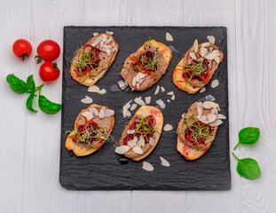 Bruschetta with pate and caramelized onions on a stone board