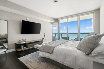 Luxury bedroom with wall to wall windows with ocean view.