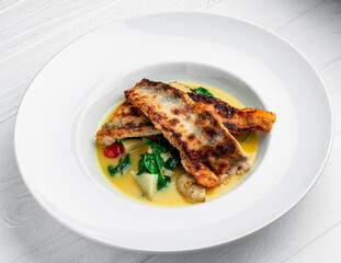 Fried perch fillet with boiled potatoes in a creamy sauce