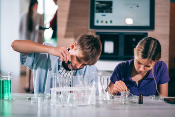 Cheerful teenage students studying in chemical lab test, Classroom learning and education concept
