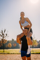 Fitness couple having fun, outdoors, on a sunny day