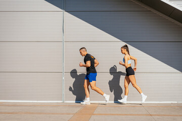 Lovely couple running together. Daily routine