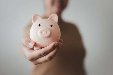 Woman holding piggy bank in concept of saving money. Finance and banking concept piggy bank on...