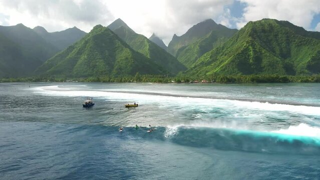 Tahiti drone 4k. Surf boat. Exotic tropical island, waves in ocean lagoon, mountains. Aerial view of French Polynesia. Teahupoo is a famous surfing destination near Papeete. Slow motion. 
