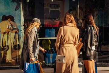 Fashionable girls looking for a handbag