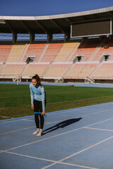 Fototapeta premium Beautiful sporty girl at the stadium