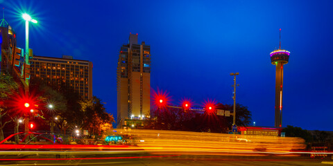 San Antonio Texas night street landscape at moon rise with car light trails, skyline buildings, and...