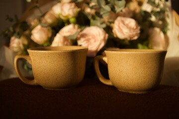 bouquet of flowers on the table with cups of coffee